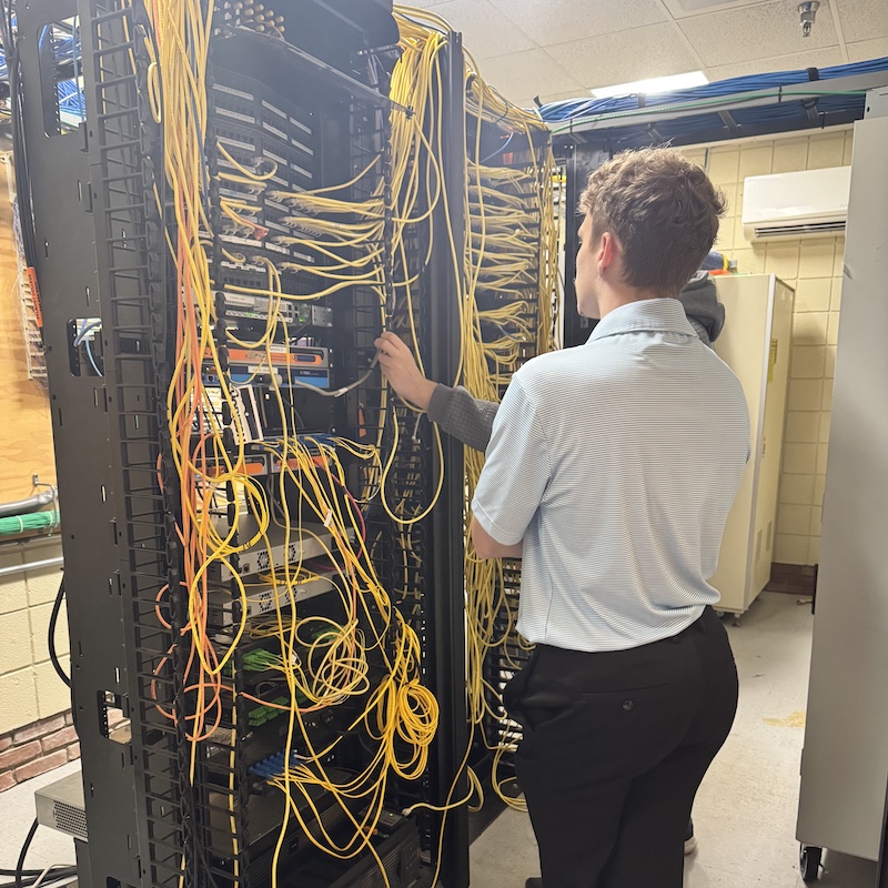 Brayden looking at at computer network wiring