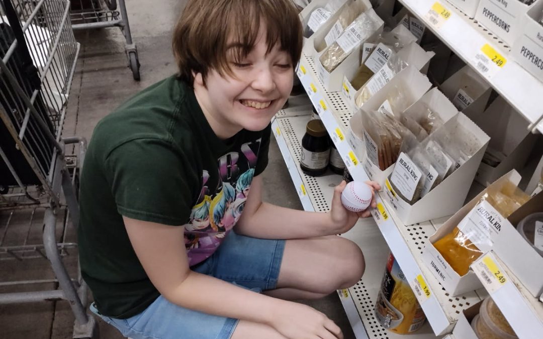 Annabelle crouched down and stocking shelves