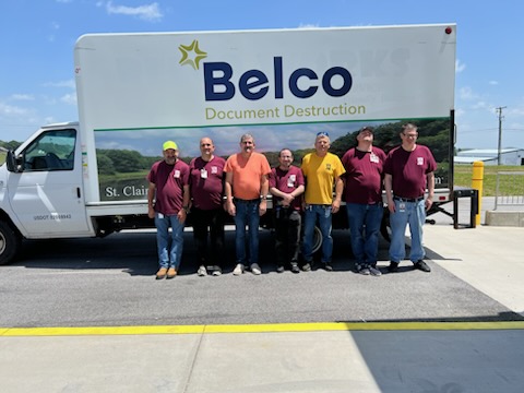 Document destruction truck with people in front of it