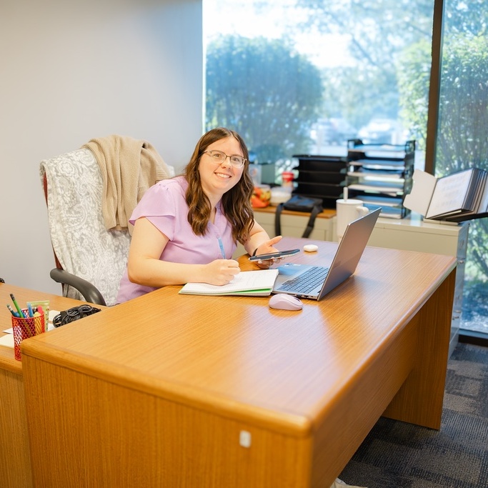 Stephanie at desk with laptop